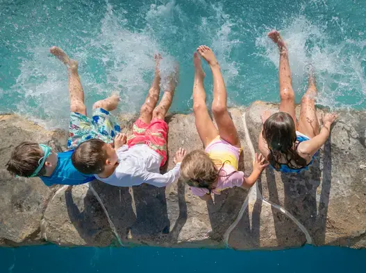 Kids are splashing in the lazy river at centara mirage beach resort dubai