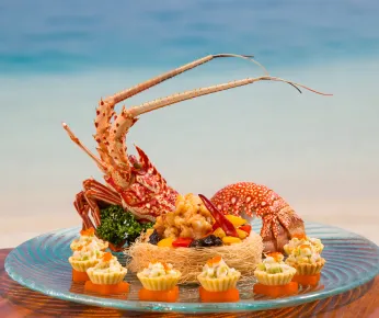 Discover the diversity of Maldivian cuisine beyond just seafood with this guide to 5 must-try dishes. From traditional fried yams and saagu bondibai pudding to fish-based sauce rihaakuru and live lobsters, there's something for everyone to enjoy in Maldives gastronomy. Learn about the blend of Indian, Sinhalese, and Arabic influences that make the Maldives' food unique, and find out where to get the best bites in the country.